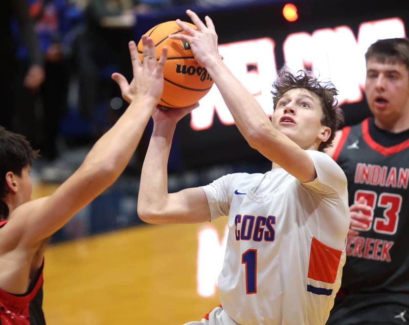 Genoa-Kingston's Kash Sunderlage goes to the basket between two Indian Creek defenders during their game Friday, Jan. 2, 2026, at Genoa Kingston High School.