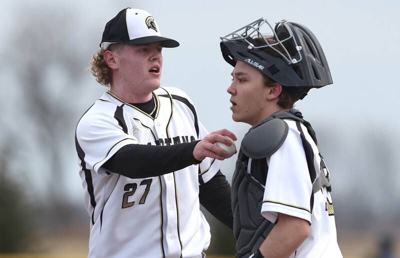 Sycamore pitcher Jimmy Amptmann talks to catcher Kyle Hartmann during their game against Burlington Central Tuesday, March 21, 2023, at Sycamore Community Park.