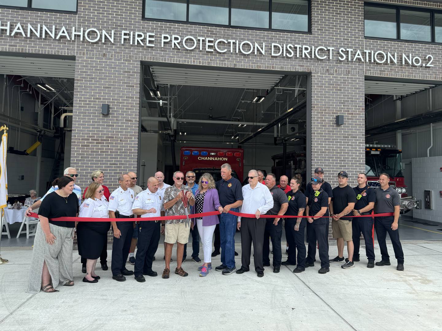 Members of the Grundy County Chamber of Commerce join the Channahon Fire Protection District for the ribbon cutting on its new fire station.
