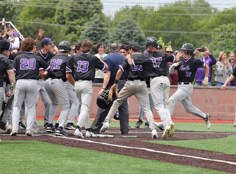 Downers Grove North's Jimmy Janicki approaches home after his walk-off homerun in the bottom of the 7th during the IHSA Class 4A baseball regional final between Downers Grove North and Hinsdale Central at Bolingbrook High School on Saturday, May 27, 2023.