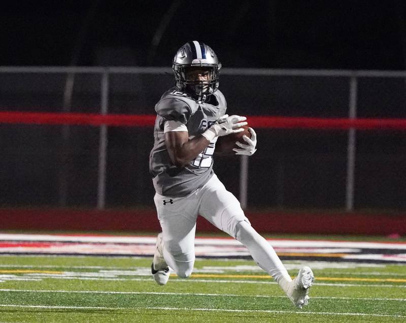 Oswego East's Jasiah Watson (13) runs after the catch against Yorkville during a football game at Yorkville High School on Friday, Oct. 13, 2023.