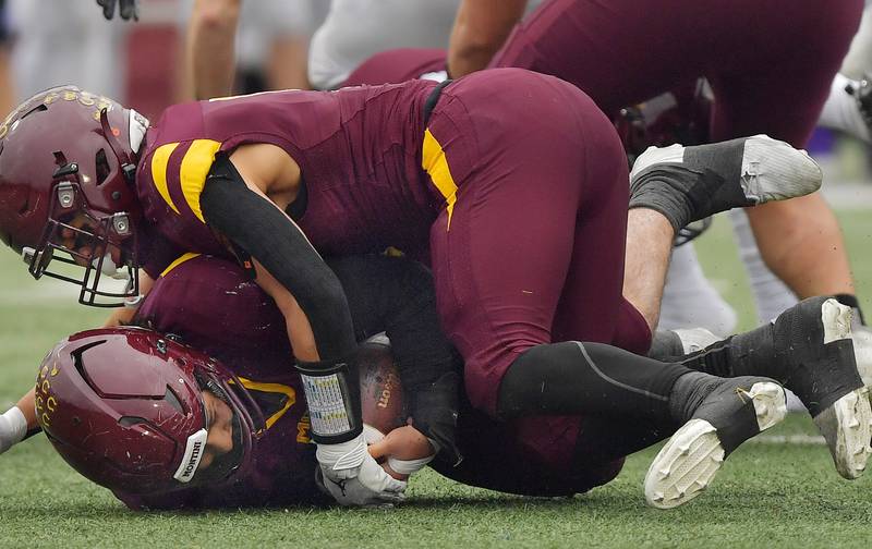 Montini's Nicky Castaldo (bottom) recovers a Wilmington fumble during a Class 3A semifinal game on November 23, 2024 at Montini Catholic High School in Lombard.