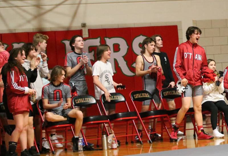 Members of the Ottawa wrestling team cheer during a wrestling meet against L-P in Sellett Gymnasium on Wednesday Dec. 7, 2022 at L-P High School.
