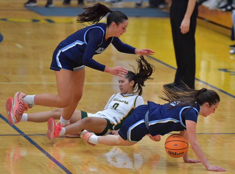 Nazareth’s Samantha Austin (top) Sophia Towne crash to the floor after a collision with Waubonsie Valley’s Maya Pereda (0) during the Class 4A Lyons Supersectional game on March 2, 2026 at Lyons Township High School in LaGrange.