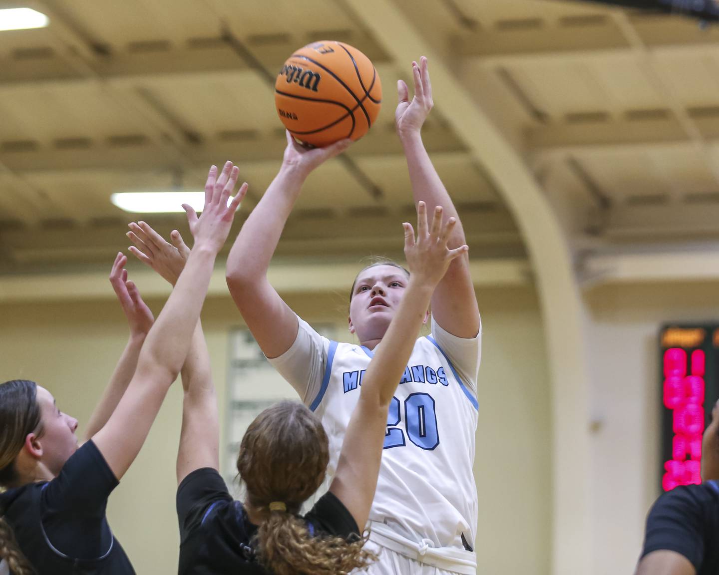 Downers Grove South's Megan Ganschow (20) puts up a shot over the defense during their York Thanksgiving Tournament matchup between Oswego East at Downers Grove South Friday, Nov 20, 2025 in Elmhurst.