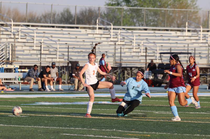 Kankakee goalkeeper Chloe Perez challenges Beecher's Elaina Kelly to knock away the ball during Kankakee's 8-4 victory over Beecher on Wednesday, April 22, 2026.