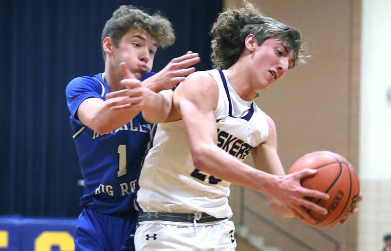 Serena's Bradley Armour grabs a rebound in front of Hinckley-Big Rock's Tyler Smith Friday, Feb. 3, 2023, during the championship game of the Little 10 Conference Basketball Tournament at Somonauk High School.
