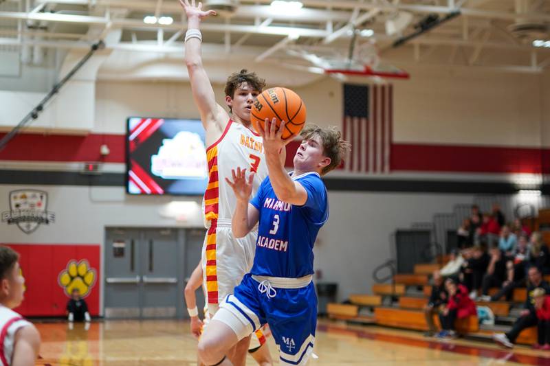 Marmion's Mac Moore drives to the basket against Batavia's Jax Abalos during a basketball game at Batavia High School on Wednesday, Nov. 27, 2024.