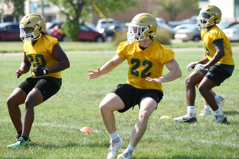 From left, Bishop McNamara's Jordan Callaway, Rhys Landsman and Julius May break down during a special teams drill at practice Monday, Aug. 11, 2025.