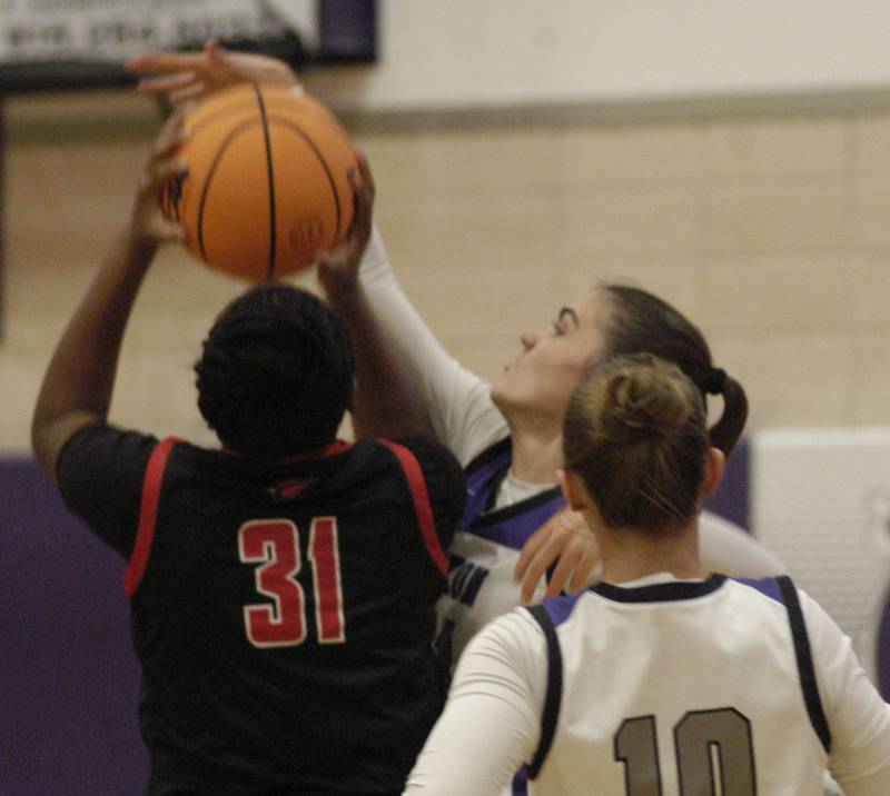 Dixon's  Kiley Gaither blocks a shot from Stillman's  Kaiya Hildreth.t  .The Dixon Duchesses played  the Stillman Valley Cardinals in the third place game of the Dixon Holiday Tournament at Dixon High School on Monday, December 29th, 2025.