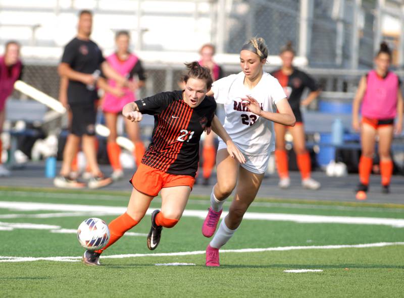St. Charles East’s Kara Machala (left) and Batavia’s Hannah Hickman go after the ball during a Class 3A West Chicago Sectional semifinal on Tuesday, May 23, 2023.