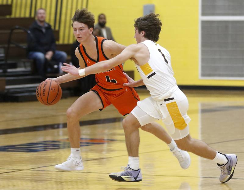 McHenry's Dylan Hurckes pushes the ball up the court against Jacobs' Ben Jurzak during a Fox Valley Conference boys basketball game on Wednesday, Nov. 29, 2023, at Jacobs High School in Algonquin.