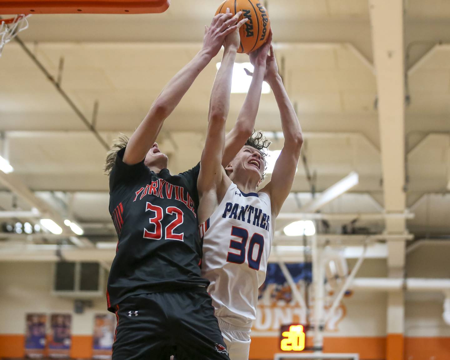Oswego's Brayden Borrowman (30) battles Yorkville's Joey Jakstys (32) for possession during their basketball game between Yorkville at Oswego, Feb 7, 2026 in Oswego.