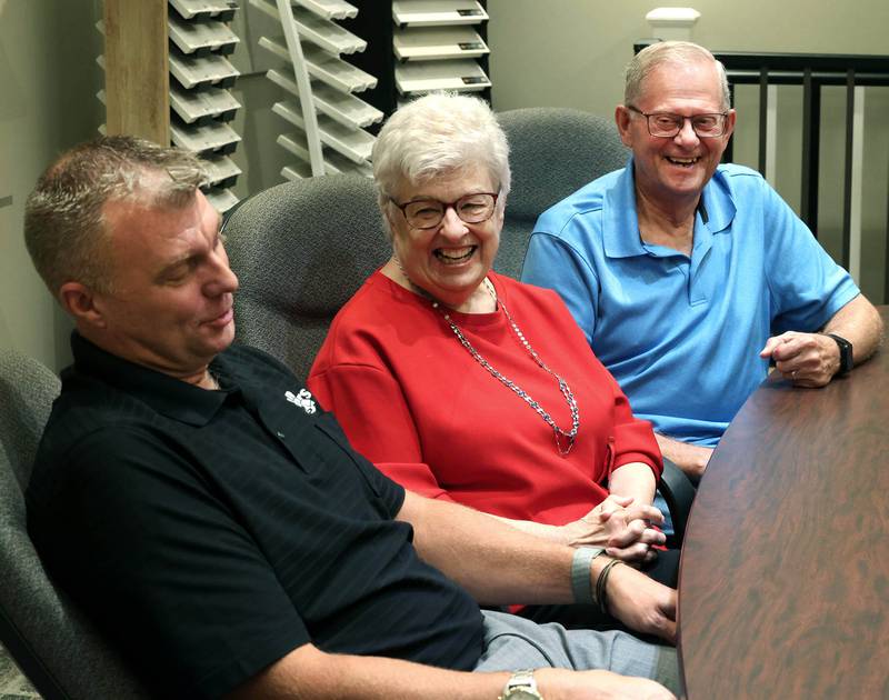 Greg Spears, (left) Ken Spears Construction president, and his parents and company founders, Ken and Kathy Spears have a laugh when talking about working with family Friday, Aug 22, 2025, at the business in DeKalb. The company is celebrating its 50th anniversary this year.