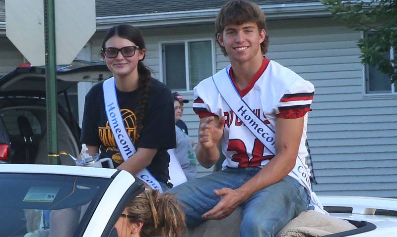 Putnam County High School senior court students Addy Leathermann and Jonathon Stunkel ride during the inaugural Homecoming parade on Wednesday, Sept. 17, 2025 down Elm Street in Granville.