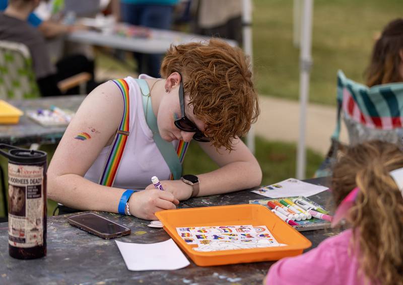 Payton Sugg, 13, of Ottawa creates some artwork Saturday afternoon at the Open Space Art Gallery & Studios tent in Central Park during the pride festival in Ottawa.