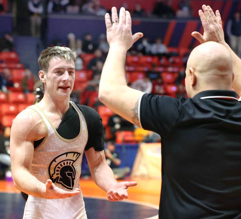 Sycamore’s Zack Crawford and his coaches celebrate his win over Washington’s Zane Hulet in the Class 2A 160 pound 3rd place match Saturday, Feb. 18, 2023, in the IHSA individual state wrestling finals in the State Farm Center at the University of Illinois in Champaign.