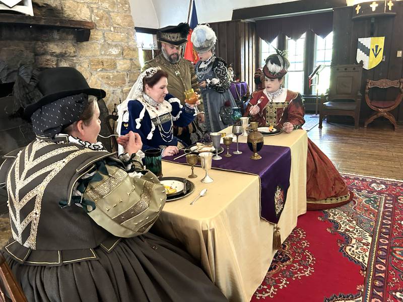 The queen and her court enjoy a meal in the Great Hall at Stronghold Castle during the Olde English Fair at Stronghold Camp & Retreat Center on Saturday, Oct. 5, 2024. The fair is held during the Autumn on Parade festival in Oregon.