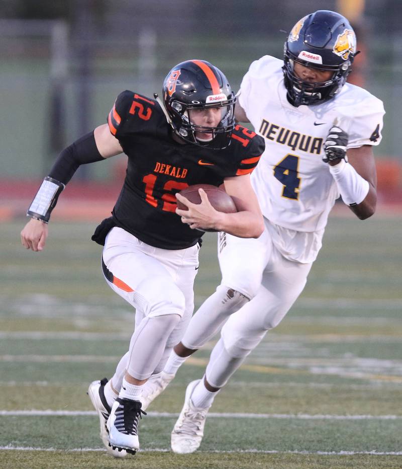 DeKalb quarterback Trenton Kyler breaks out ahead of Neuqua Valley's Laine Jenkins during their game Friday night at DeKalb High School.