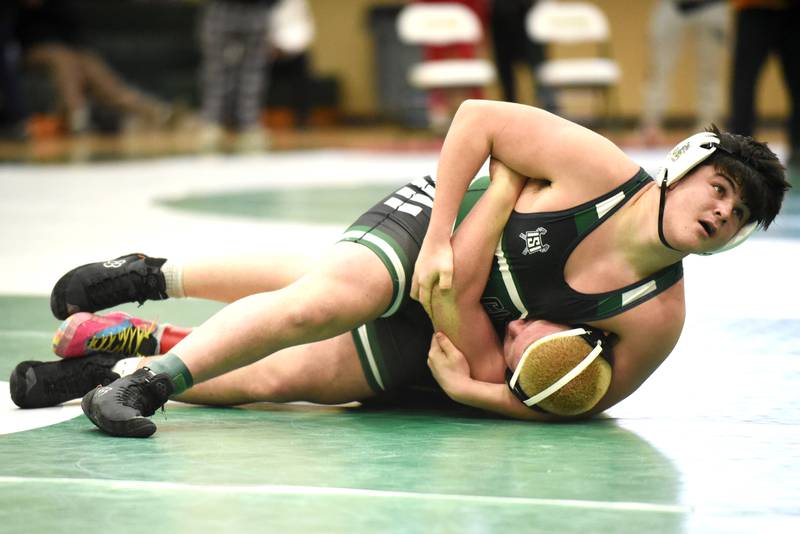 Coal City's John Keigher, top, looks to the clock as he establishes position on Reed-Custer's Dominic Alaimo during the 215-pound championship match at the IHSA Class 1A Coal City Sectional Saturday, Feb. 15, 2025.