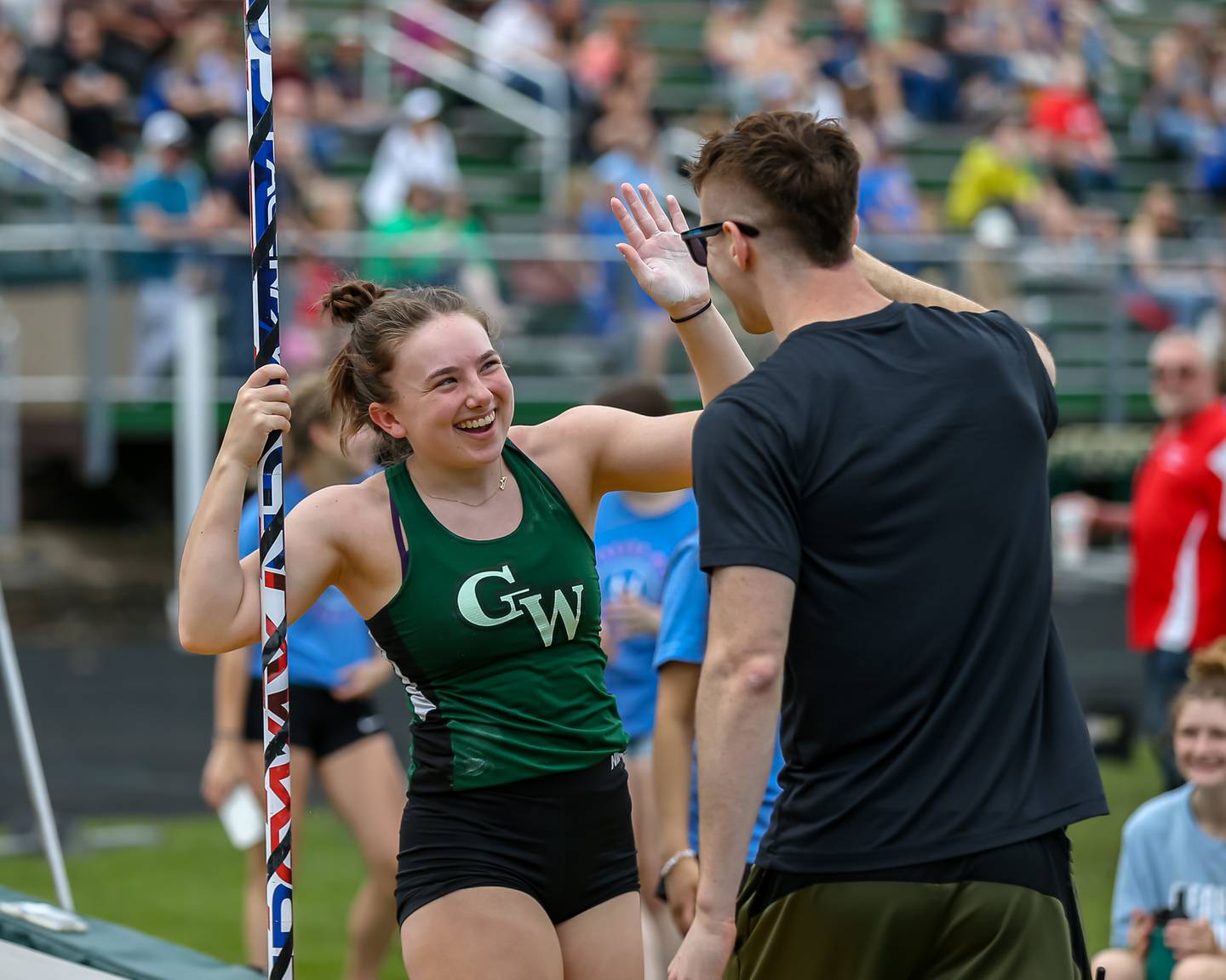 Glenbard West's Nina Wintermute is congratulated after making a successful vault at the Glenbard West's Sue Pariseau Girls Track and Field Invitational.  April 23.2022.