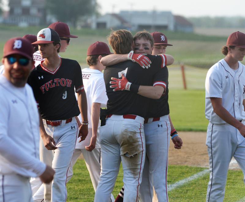 Fulton's Kole Shippert embraces AJ Boardman following the Steamers 7-6 loss to Dakota at the 1A Pearl City Sectional on Wednesday, May 24.