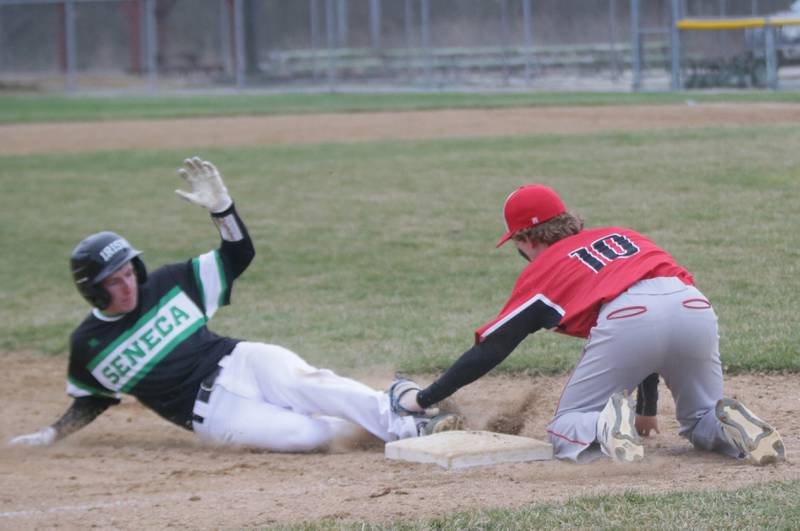 Seneca's Owen Quigley slides safely into third base as Henry-Senachwine's Troy Westerdahl (10) applies the tag Monday, April 5, 2022, in Seneca.