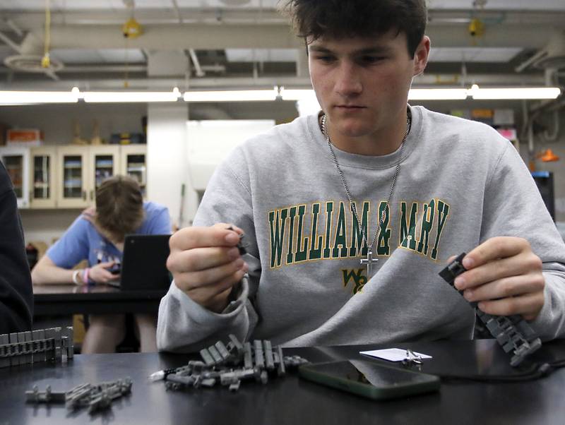 Huntley student Quin Drews takes apart his robotics project Thursday, May 18, 2023, during class at Huntley High School. Huntley Community School District 158 has been recognized as a 2023 Spring “Lighthouse System” by AASA, The School Superintendents Association, to serve as a model of positive change in public education. It is one of six school districts from across the country to receive the award.