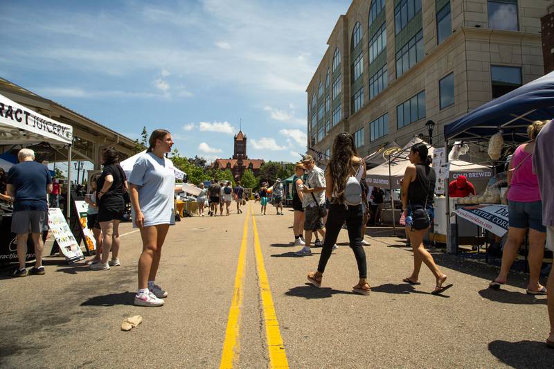 Attendees visit different vendors and listen to music performed during Make Music Wheaton and the Wheaton French Market in The Wheaton French Market Plaza on Saturday, June 21, 2025.