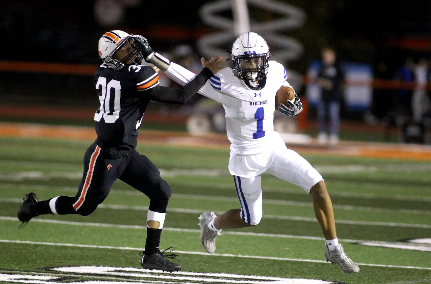 Geneva’s Talyn Taylor (1) blocks St. Charles East’s Cayman Manuel during a game at St. Charles East on Friday, Sept. 30, 2022.