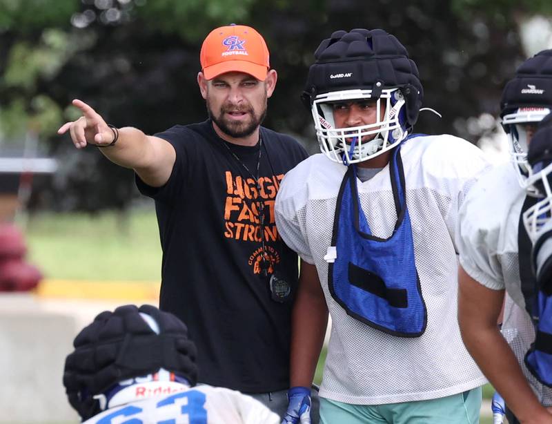 Genoa-Kingston head coach Cam Davekos gives some instruction to a player Tuesday, Aug. 19, 2025, during practice at the school.