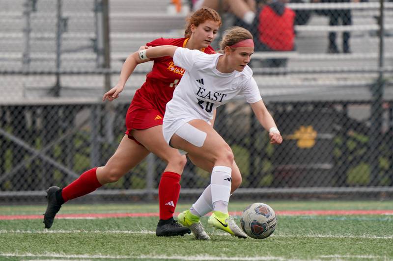 Oswego East's Catie Sloan (right), plays the ball against Batavia’s Gianna Reid during a soccer match at Batavia High School on Saturday, March 29, 2025.