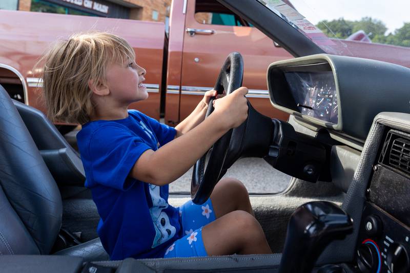Adore Riebe sits in a DeLorean at the 20th annual Cruise Night on Friday, August 8, 2025, on Main Street in Marseilles.