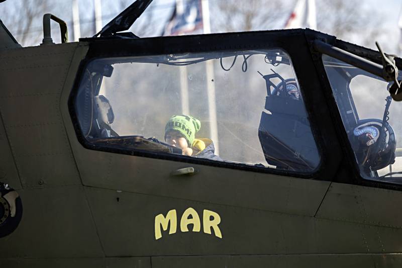 Alex Brown, 9, peers into the gunship on display at Veterans Memorial Park in Dixon following the Veterans Day ceremony there Saturday, November 11, 2023.