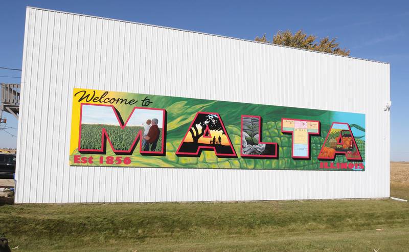 The new mural by Dixon artist Nora Balayti Wednesday, Oct. 19, 2022, on the north side of Route 38 in Malta. The mural, which spells out Malta in large capital letters, depicts the values of the town with themes of agriculture, family, community and growth.