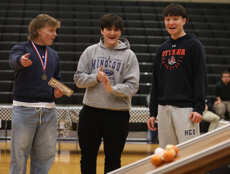 Ottawa Township High School students (from left) Evan Faklmaier, Charlie Wooster, and Dominic Parks watch their car travel down the ramp during the Edible Car Contest on Wednesday, Feb. 25, 2026 at Illinois Valley Community College in Oglesby.