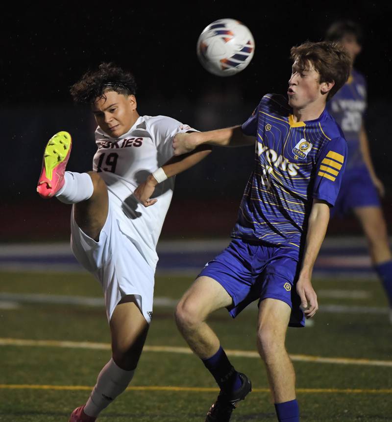 Naperville North’s Anthony Flores kicks the ball past Lyons Township’s Danny Svelnis in the Class 3A state soccer semifinal game in Hoffman Estates on Friday, November 3, 2023.