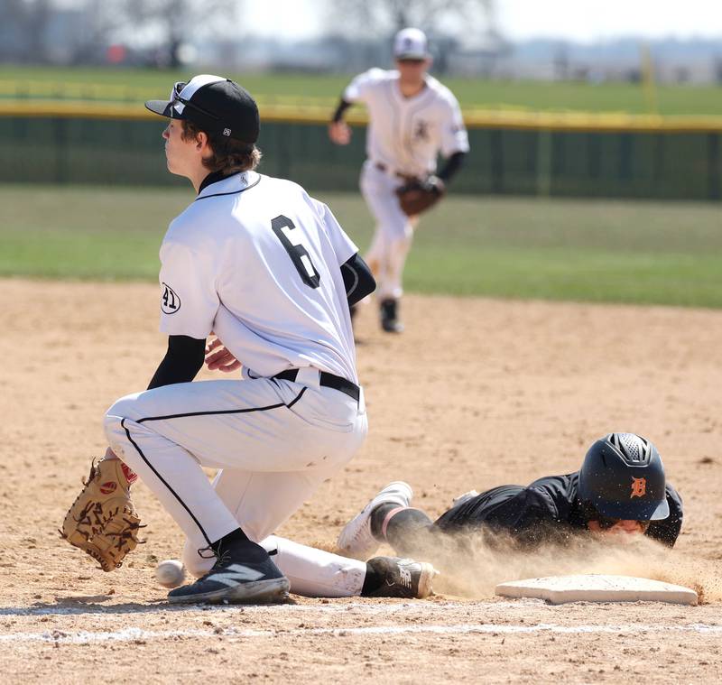 The ball scoots just under the glove of Kaneland's Dylan Borysiewicz on a pickoff attempt allowing DeKalb's Breydon Martin to advance to second during their game Saturday, April 12, 2025, at Kaneland High School in Maple Park.