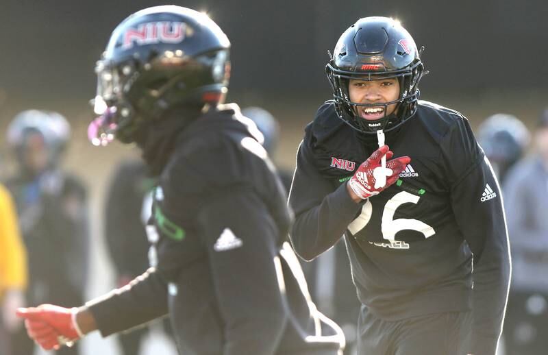 Northern Illinois University junior linebacker Jaden Dolphin (right) calls out instructions to junior linebacker Daveren Rayner during a play at spring practice Friday, April 7, 2023, in Huskie Stadium at NIU in DeKalb.