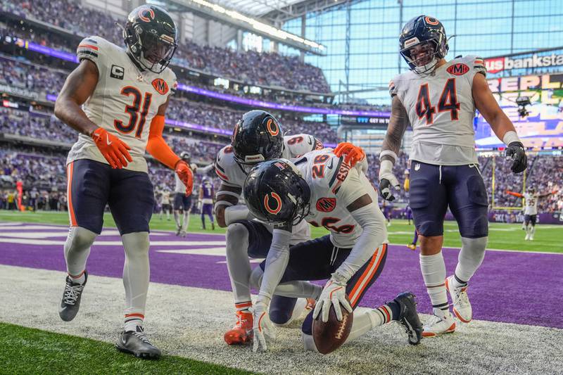Chicago Bears cornerback Nahshon Wright (26), center, celebrates after an interception during the first half of an NFL football game against the Minnesota Vikings, Sunday, Nov. 16, 2025, in Minneapolis. (AP Photo/Abbie Parr)