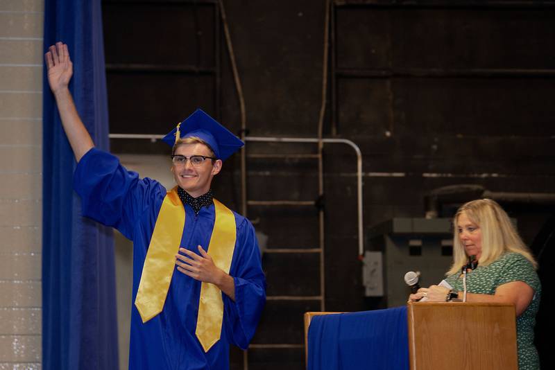 Newman graduate Koda Brininger waves to the crowd as her accepts his diploma Wednesday, May 18, 2022.