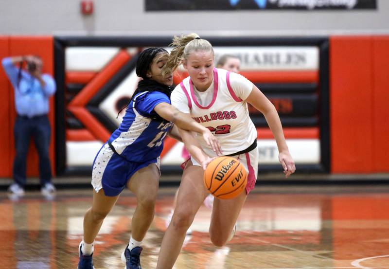 Batavia's Ali Thomas (right) goes after the ball away from Wheaton North's Brea Moore during a Class 4A St. Charles East Sectional semifinal on Tuesday, Feb. 25, 2025 in St. Charles.