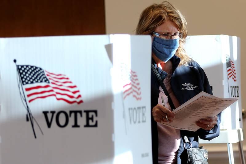 Phyllis Moister of Lakewood finishes up her ballot at Main Beach on Tuesday, Nov. 3, 2020 in Crystal Lake.