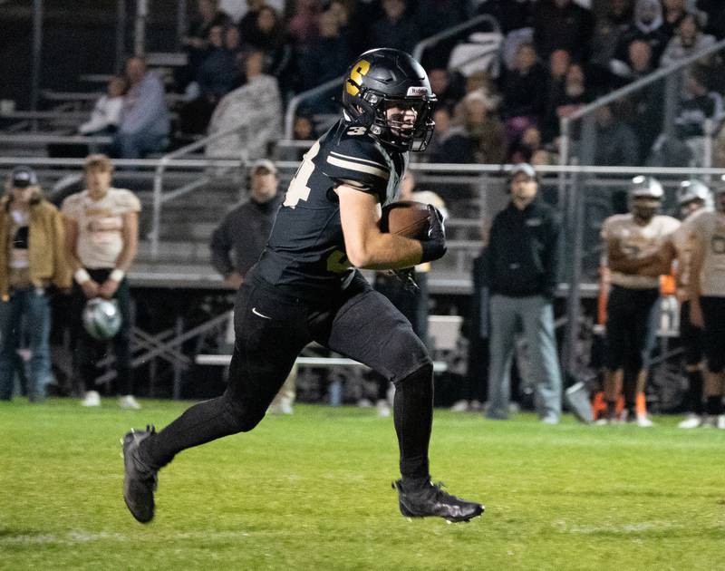 Sycamore's Joey Puleo (34) carries the ball against Kaneland during a football game at Kaneland High School in Maple Park on Friday, Sep 30, 2022.