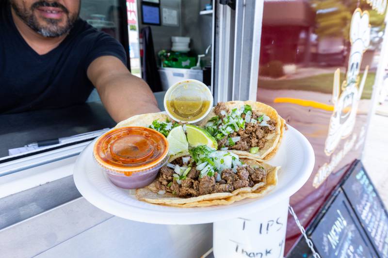 Raul Salinas holds Tacos on spatula from Salinas food truck on Monday, Aug 25, 2025 on Illinois Avenue in Mendota.