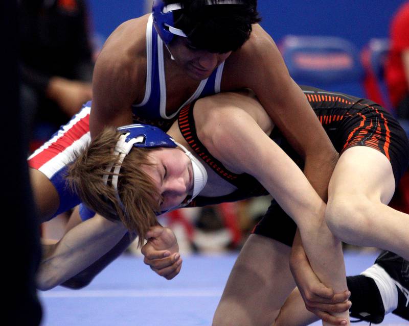 McHenry’s Myles Wagner, bottom, battles Dundee-Crown’s Chris Gerardo at 120 pounds in varsity wrestling at Carpentersville Thursday night.