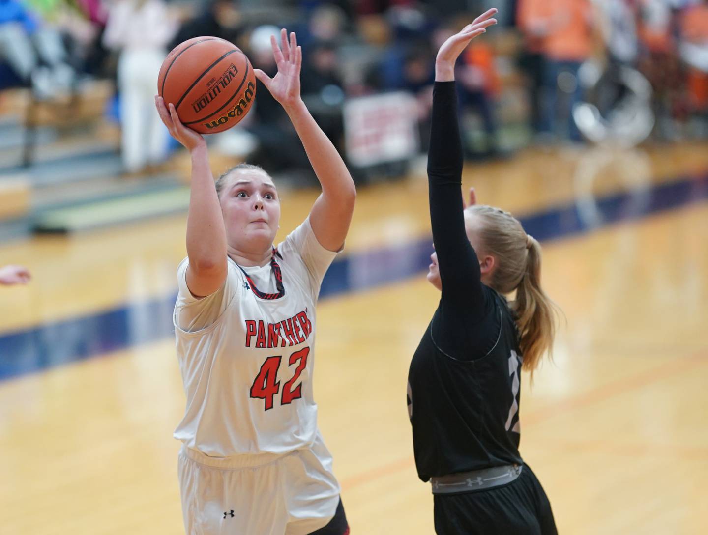Oswego’s Kendall Grant (42) shoots the ball in the post against Oswego East's Cassie Van Meter (13) during a basketball game at Oswego High School on Tuesday, Dec 12, 2023.