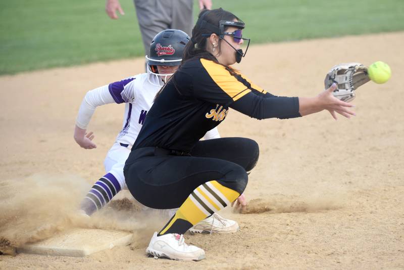 Herscher's Chloe Kinkade, right, fields a throw to third base as Wilmington's Nina Egizio slides in during a game at Wilmington Tuesday, April 15, 2025.
