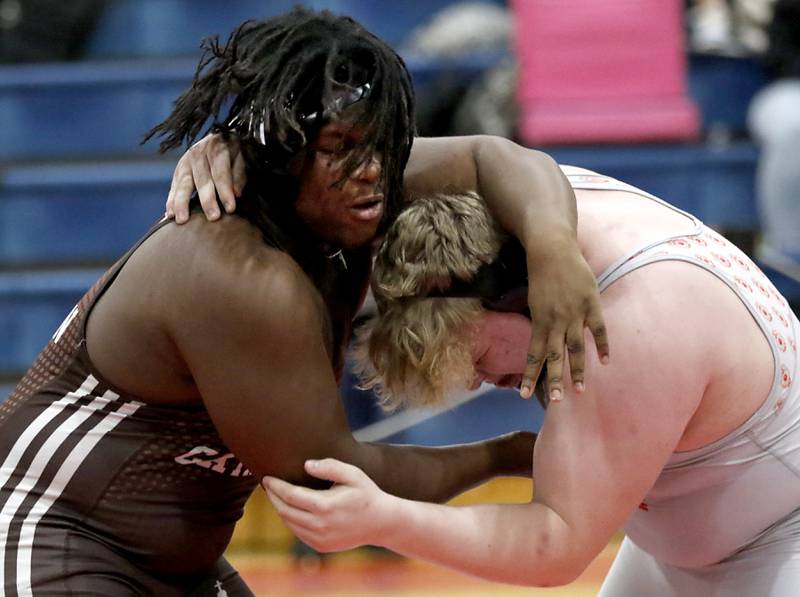 Joliet Catholic's Elijah Watt tries to control Marian Central's Kaleb Eckman in their 285-pound match during a triangle wrestling meet on Saturday Jan. 11, 2025, between Marian Central, Joliet Catholic, and Mt. Carmel at Marian Central High School in Woodstock.