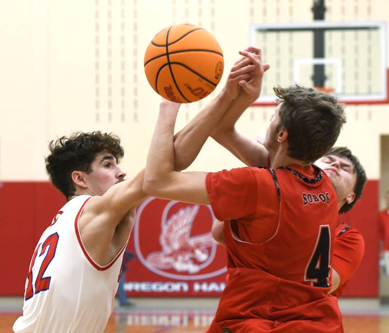 Oregon's Quinn Plescia (12) battles South Beloit's Callan Porter (4) for the ball on Monday, Nov. 24, 2025 at the Oregon Boys Basketball Thanksgiving Tournament in Oregon.